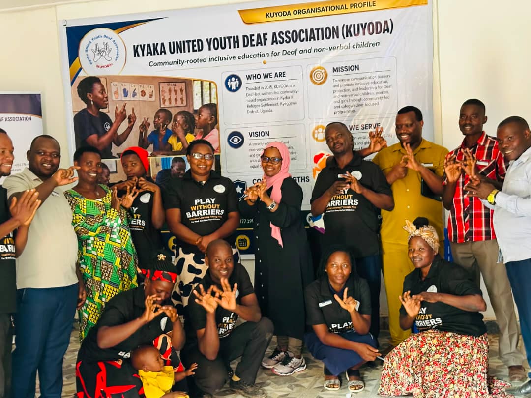 KUYODA In Visit — team and community members signing together