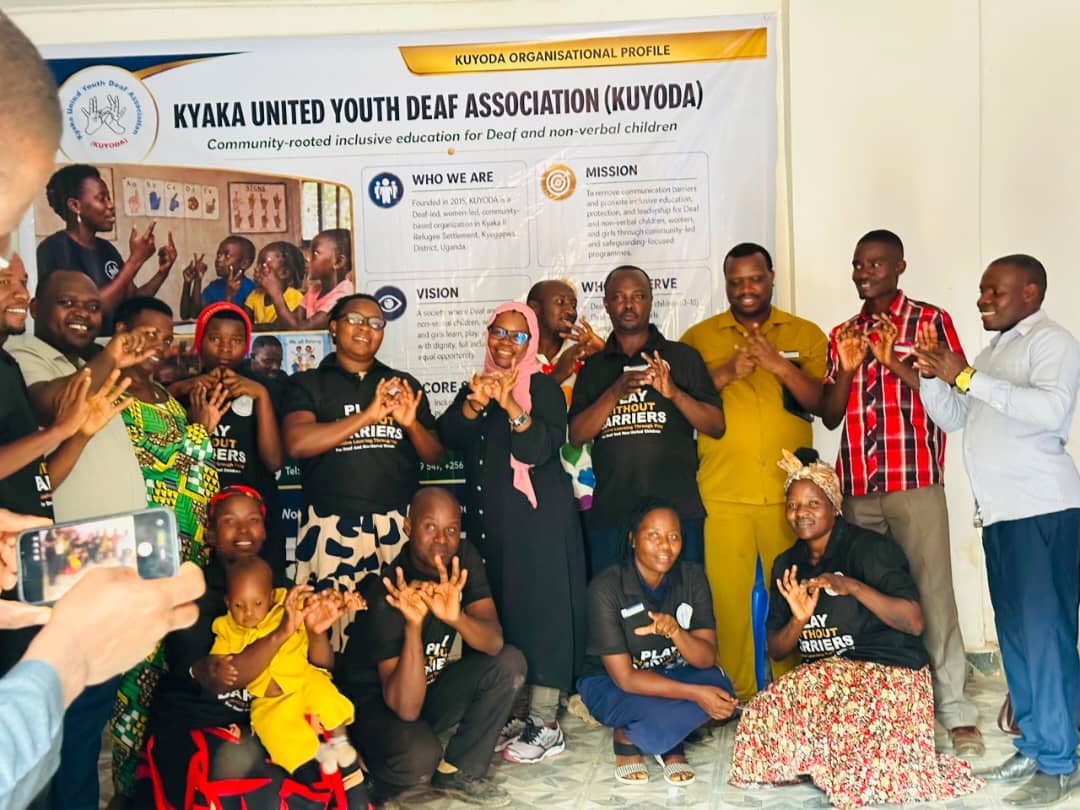 KUYODA In Visit — team and community members signing together